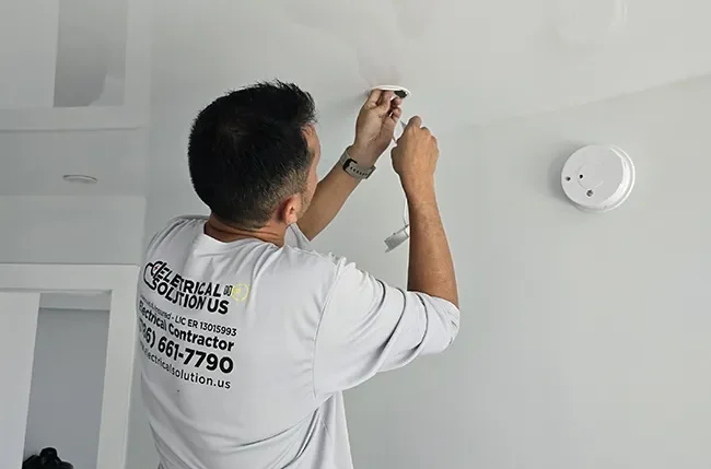Electrical Solution US technician working on a residential ceiling fixture