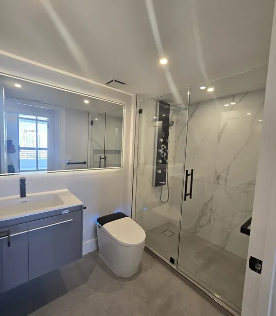 Bathroom interior with linear and recessed lighting