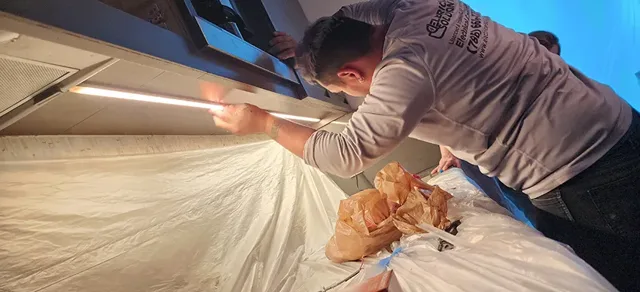 Technician fitting a ceiling finish