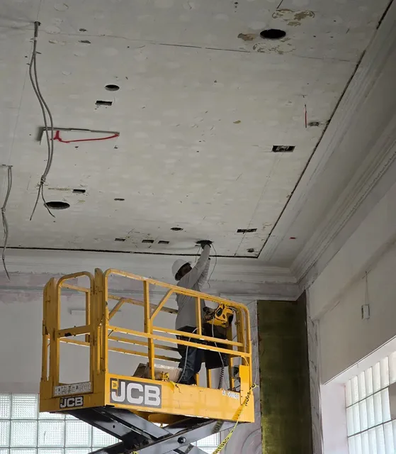 Raised work platform under an unfinished commercial ceiling