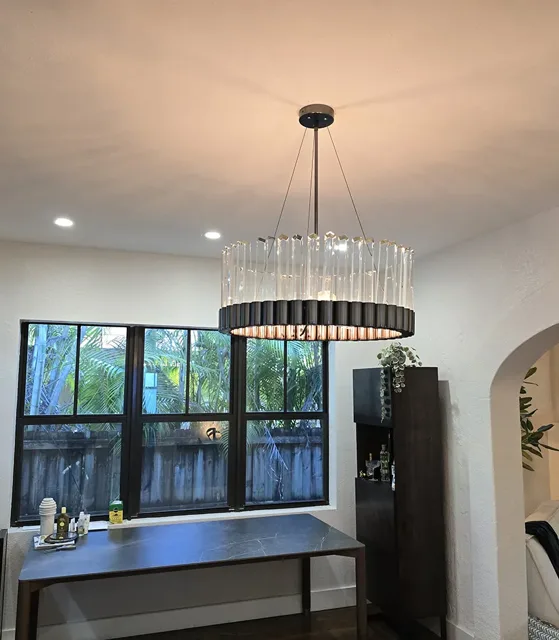 Kitchen interior with a suspended chandelier and recessed lighting