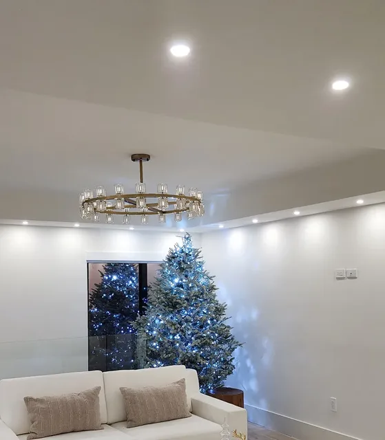 Living room with recessed ceiling lights and a chandelier