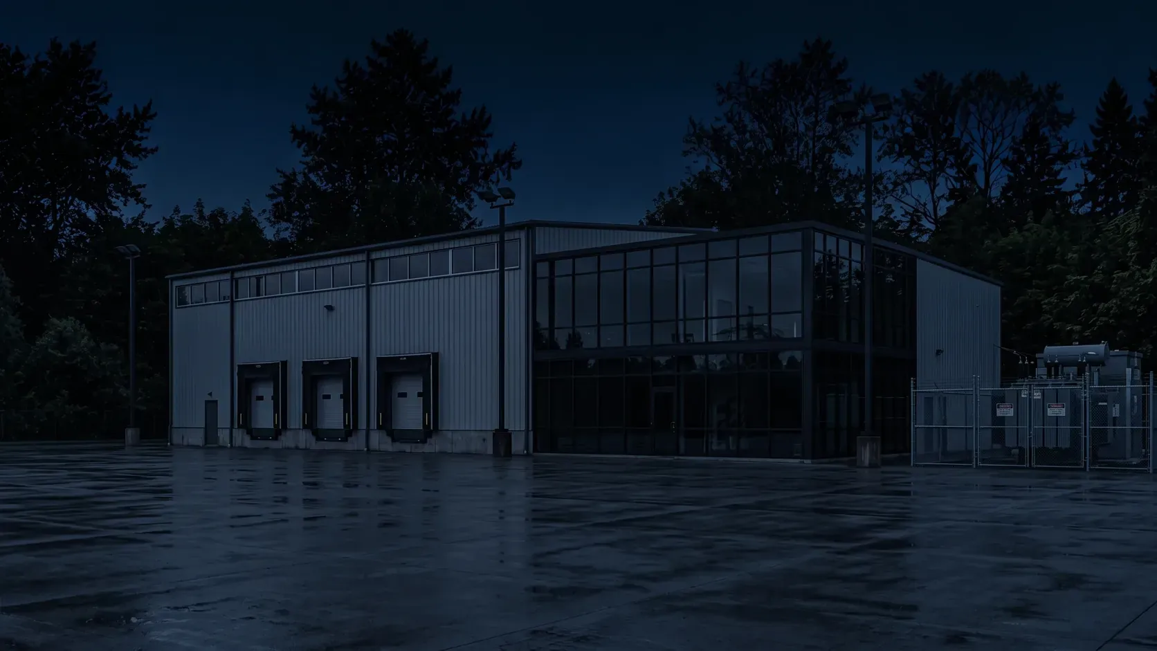Industrial warehouse and office block at night with the lights turned off